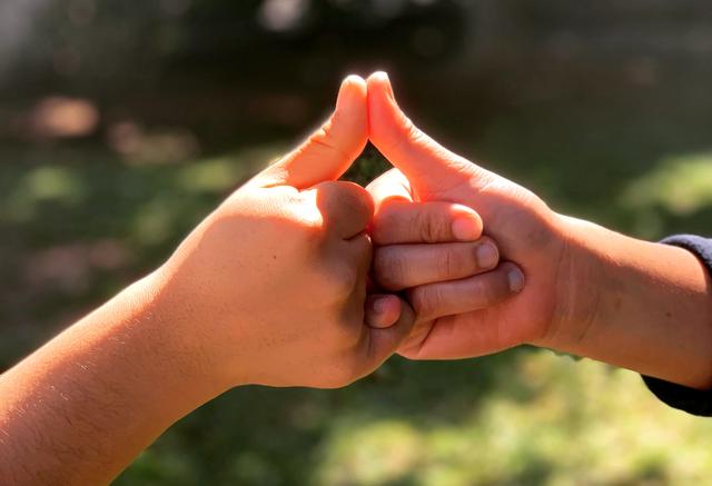 Hands holding coins for a donation