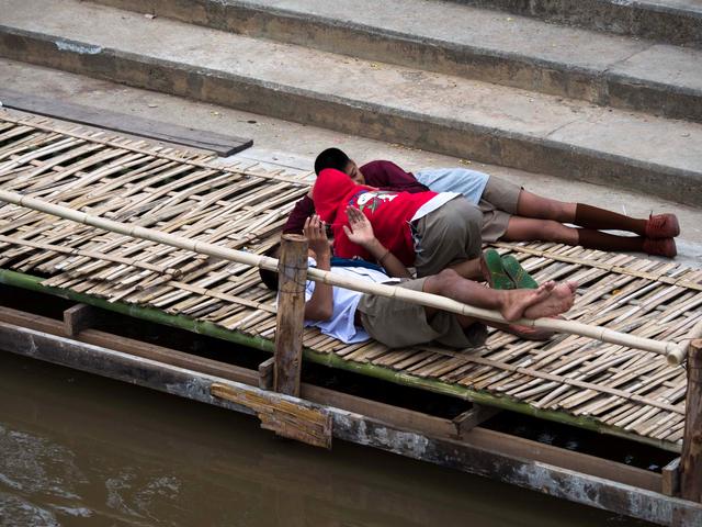 Children resting by the river